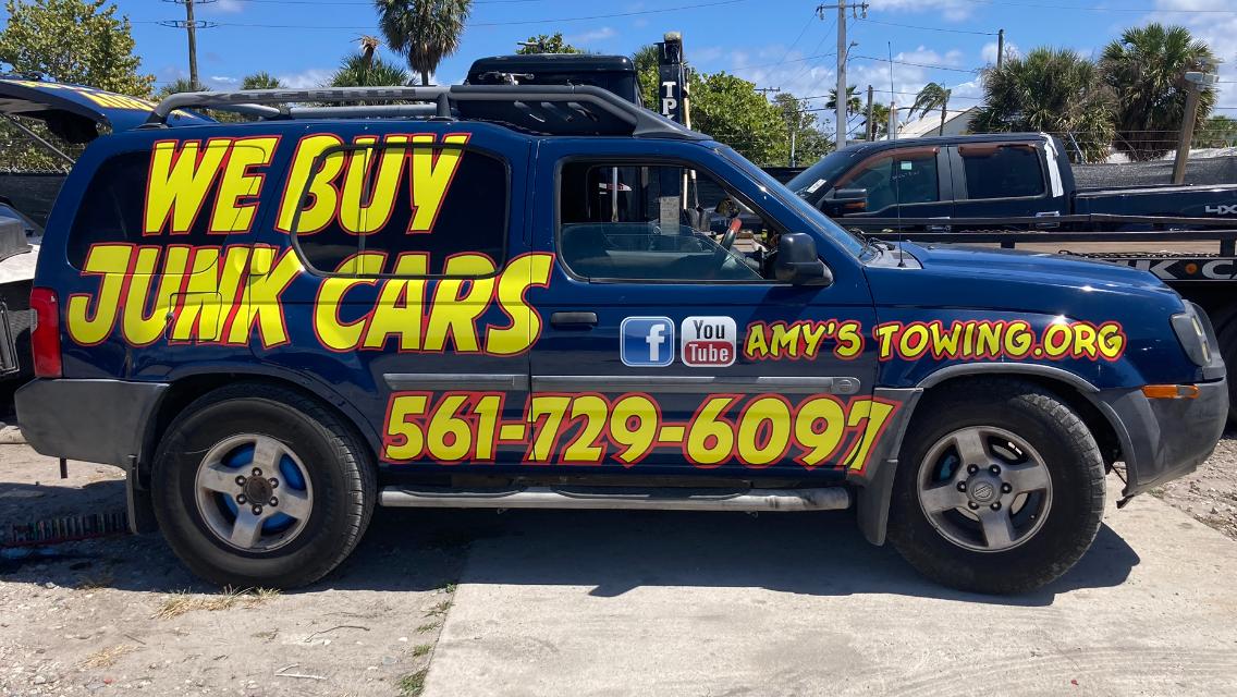 Amy’s Towing vehicle advertising that we buy junk cars